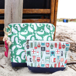 two nautical zip bags on beach