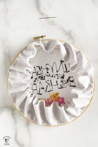 fabric gathered on the back of embroidery hoop