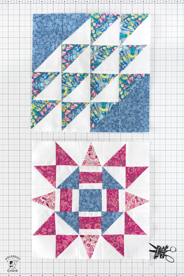 blue pink and white quilt blocks on a white cutting mat