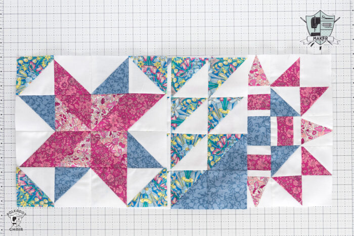 multiple red pink and white quilt blocks on white cutting mat