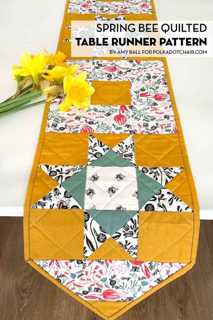 yellow, and green floral table runner on white table with flowers