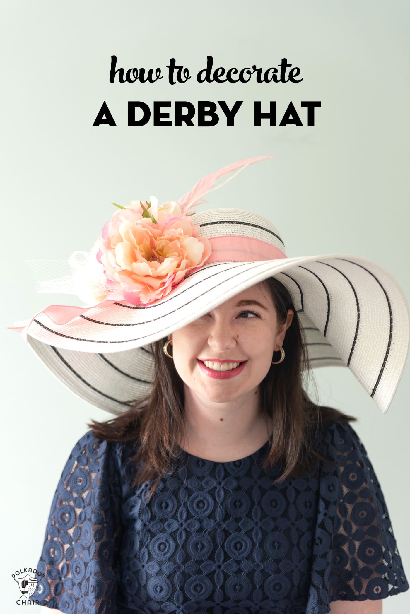 girl in white derby hat with pink flowers wearing a navy dress