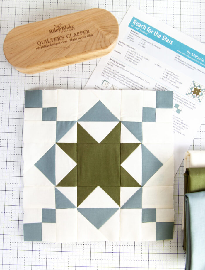 Blue and white quilt block on white cutting mat