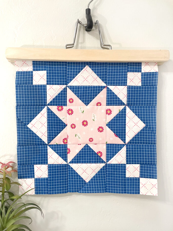 Blue and white quilt block on wood hanger