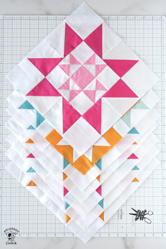 brightly colored quilt blocks on white cutting mat