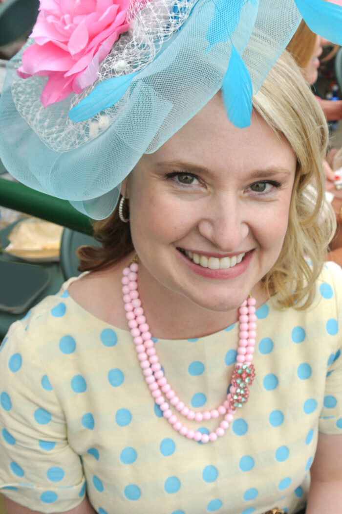 woman wearing pink and light blue fascinator
