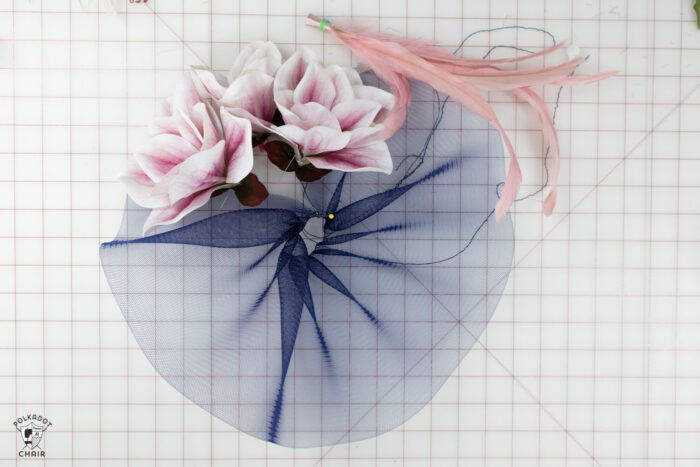 navy tulle and pink flowers on white cutting mat