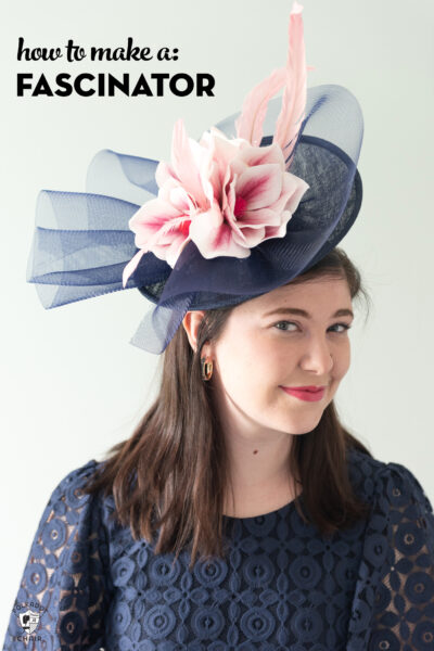 girl in navy dress wearing navy fascinator with pink flowers