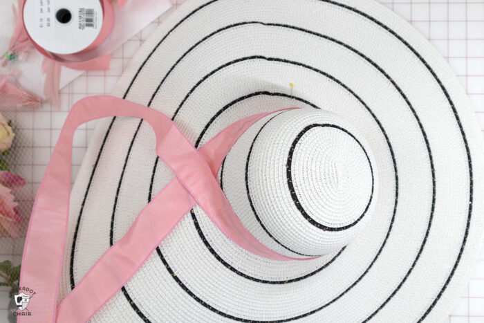 pink ribbon on black and white hat