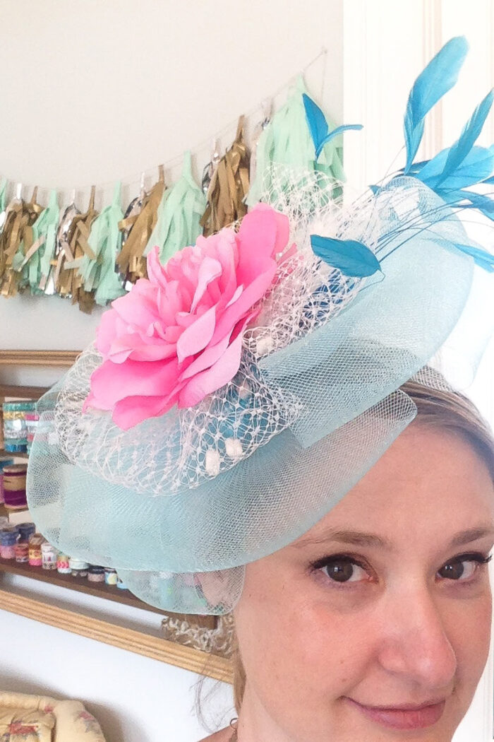 woman wearing pink and light blue fascinator