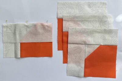 cut orange and cream fabric on white table