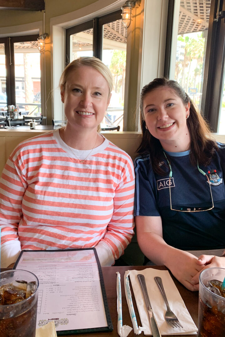 Two women sitting in booth at restaurant