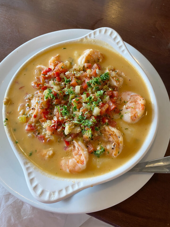 Shrimp and Grits in white bowl. 