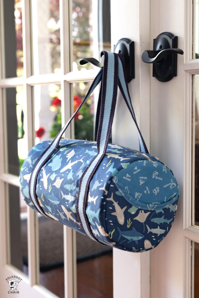 Blue duffle bag hanging on door handle