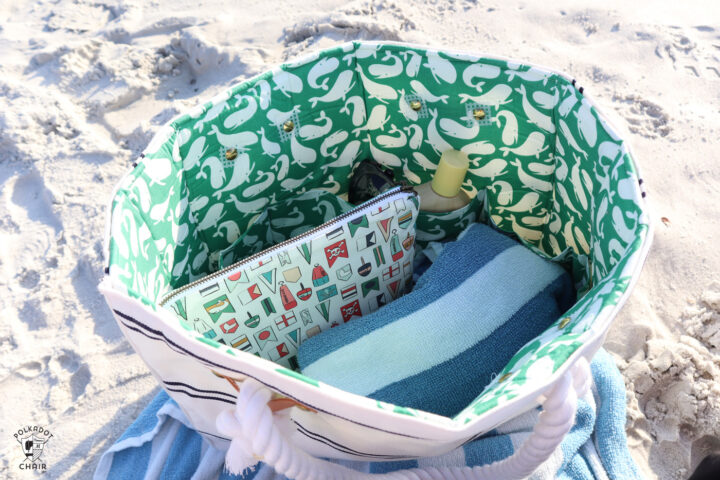 white and blue beach bag on beach