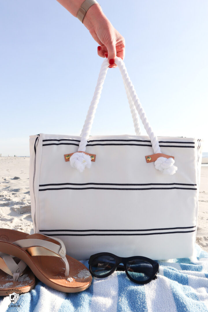 white and blue beach bag on beach