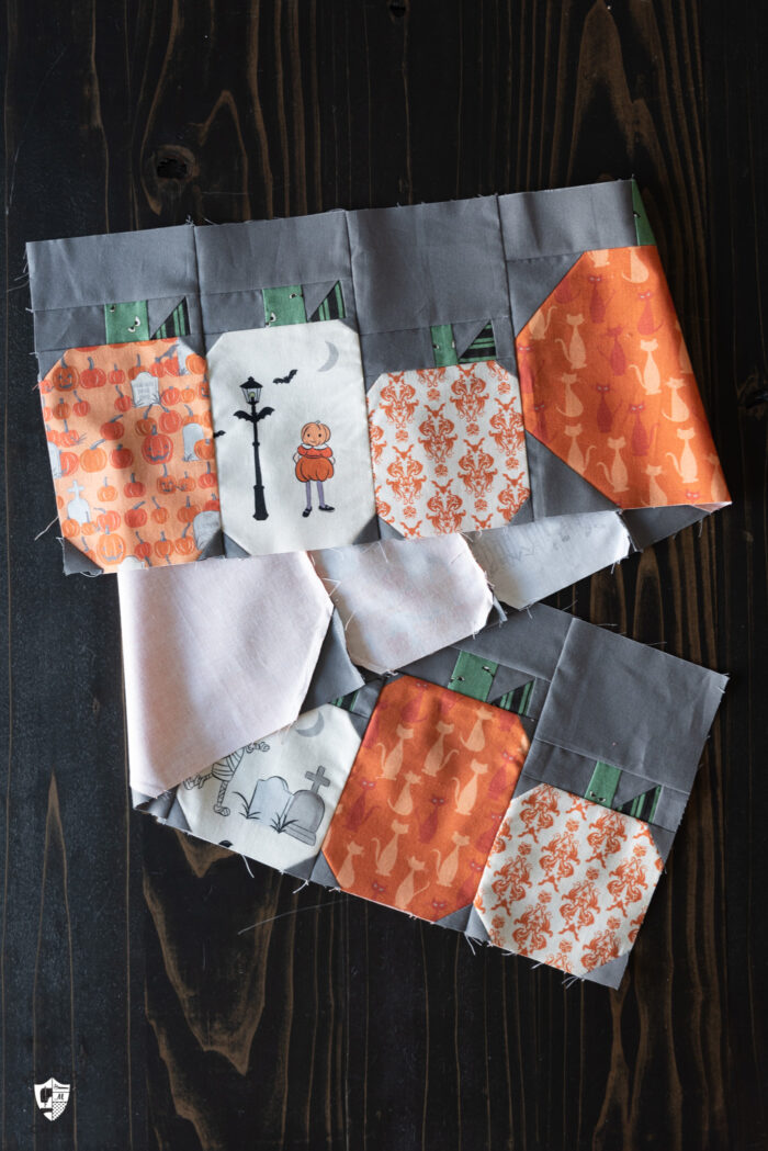 pumpkin quilt blocks sewn together on wood table