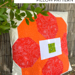 photo of orange and cream quilted pillow outdoors