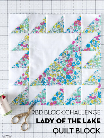 blue and white floral quilt block on white cutting mat