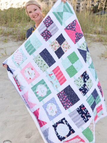 seas the day quilt pattern being held by woman
