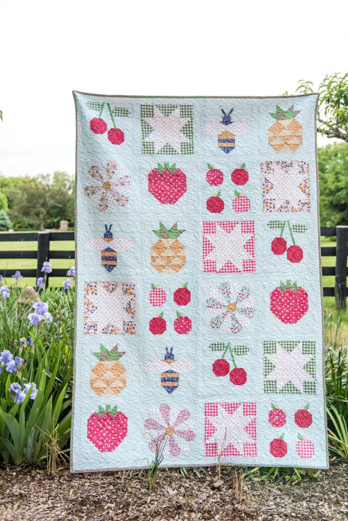 quilt hanging in front of garden