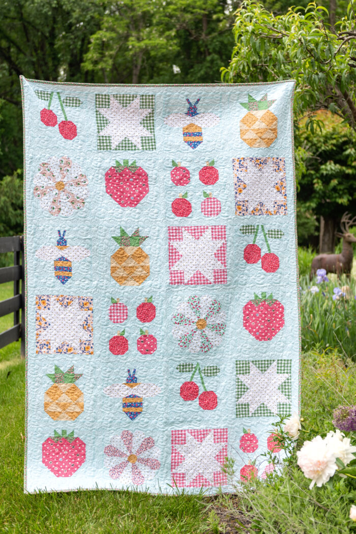 quilt hanging in front of garden