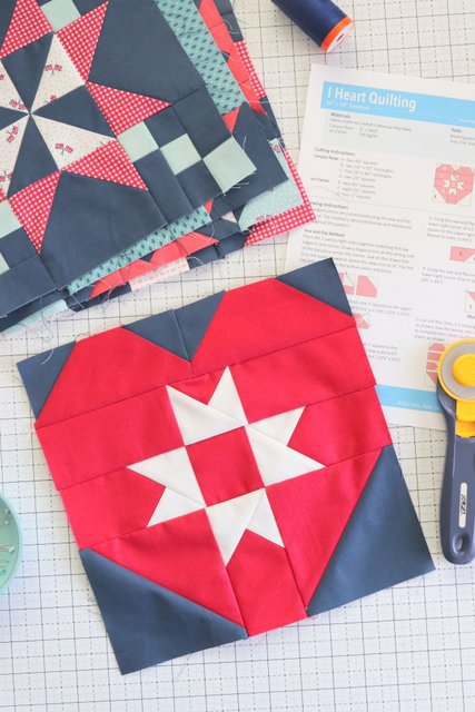 red and blue quilt block on white cutting mat