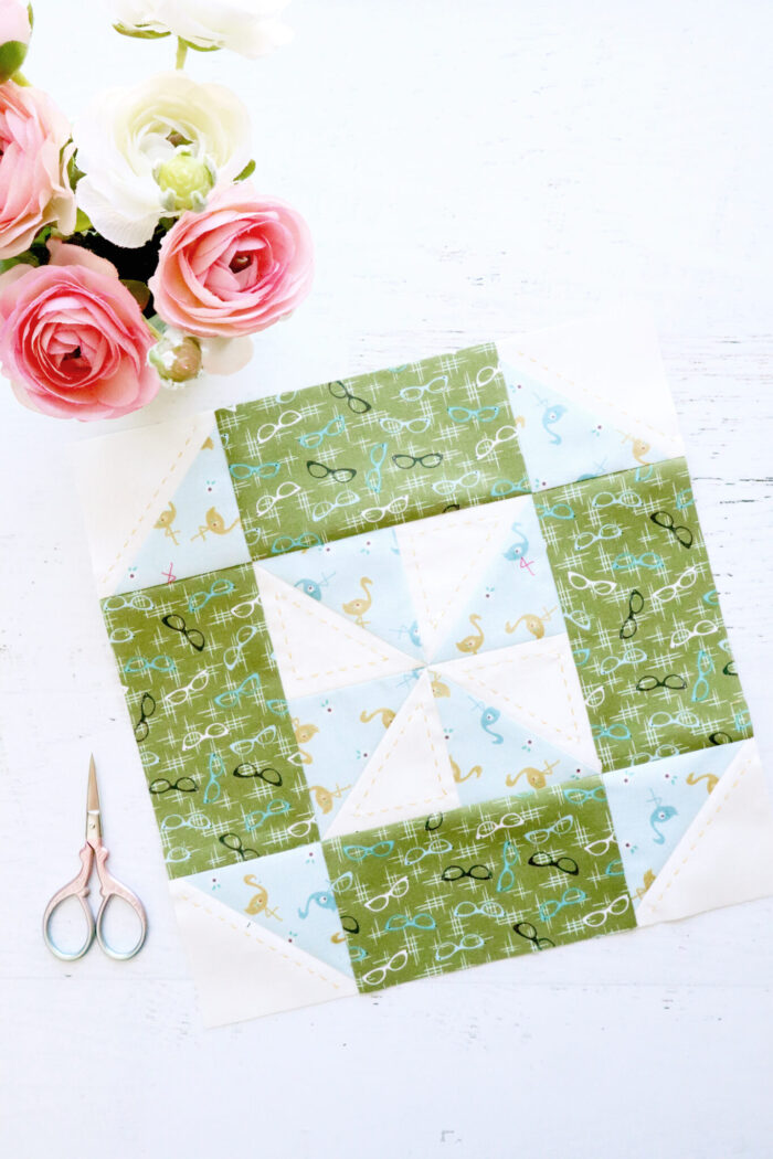 green and blue quilt block on white cutting mat