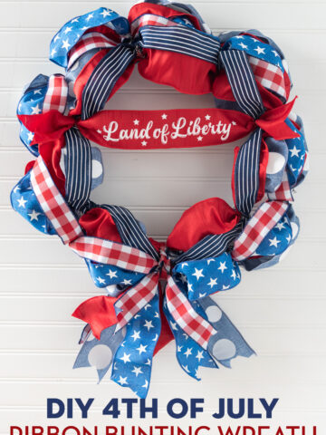 red, white and blue ribbon wreath on white wall