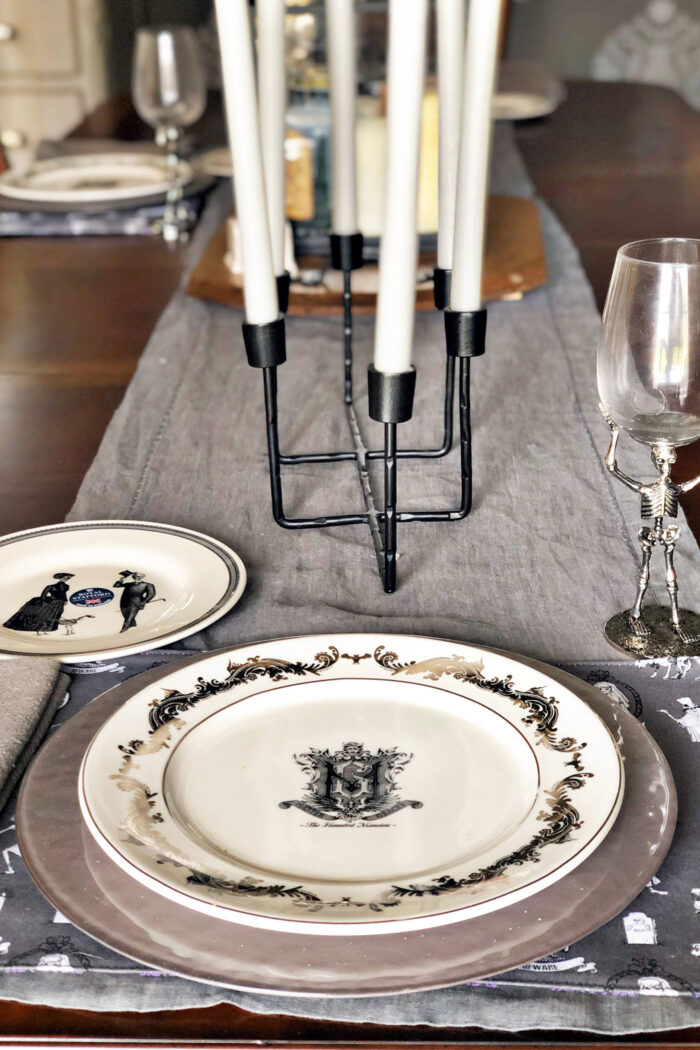 halloween table setting with gray table runner and white plates