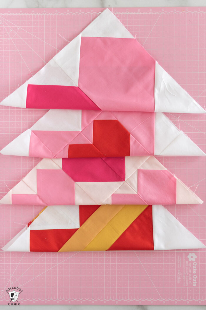 red, white and pink quilt blocks on cutting mat