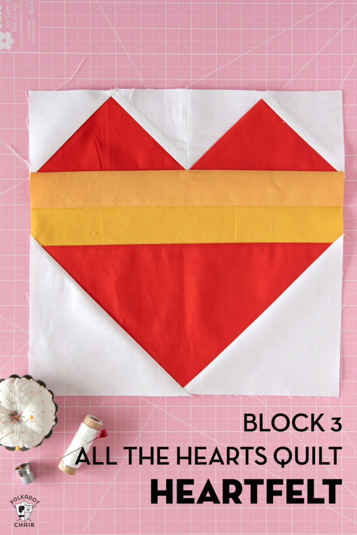 red, white and yellow quilt block on cutting mat