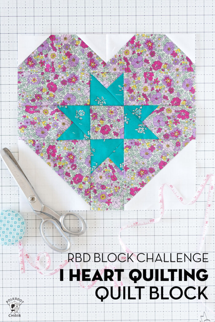 pink floral and turquoise quilt block on white cutting mat