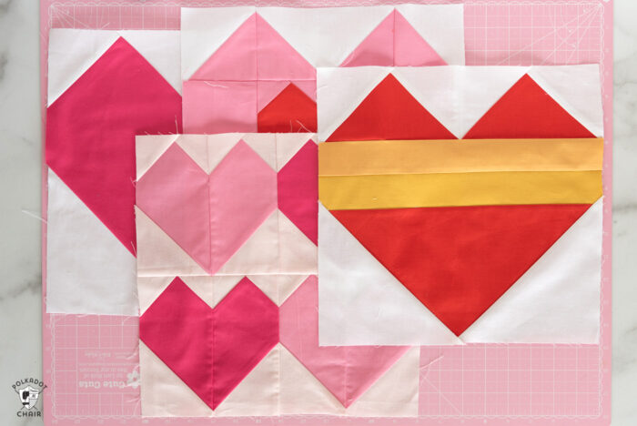 red, white and pink quilt block on cutting mat