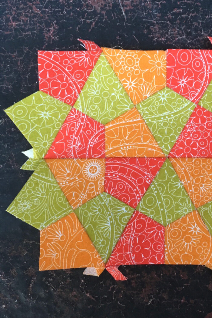 colorful quilt block on dark background