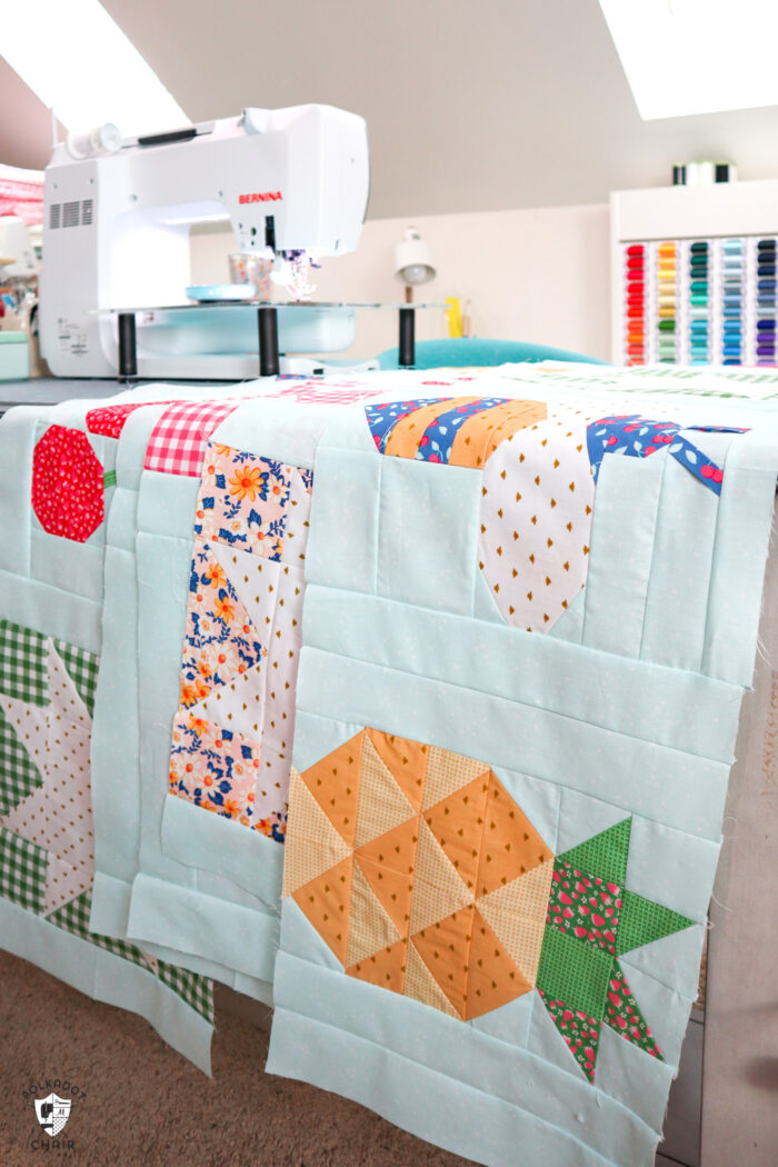 rows of quilt blocks on sewing machine table