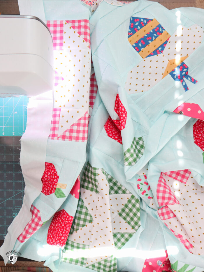 rows of quilt blocks on sewing machine table