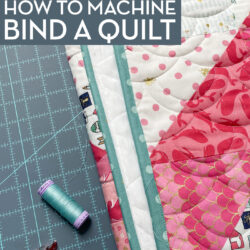 quilt, thread and clips on blue cutting mat