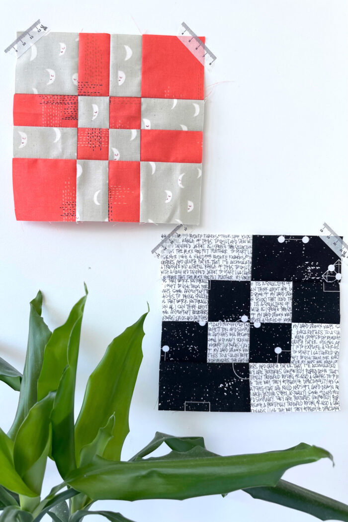 red, gray and black quilt blocks on white wall