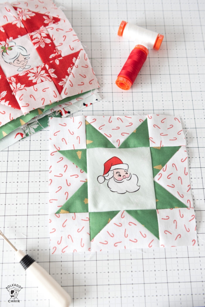 red and green christmas quilt block on white cutting mat