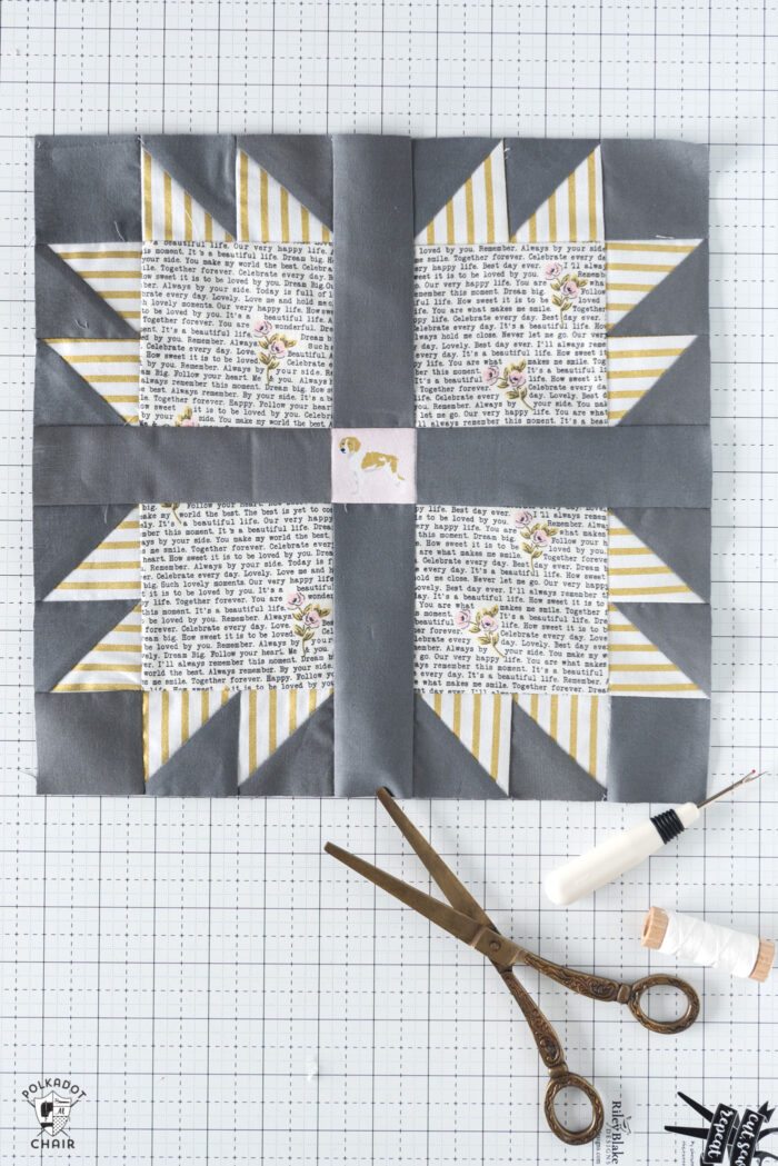 gray and yellow quilt block on white cutting mat