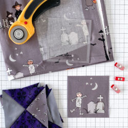 various fabrics and cutting tools on white cutting mat