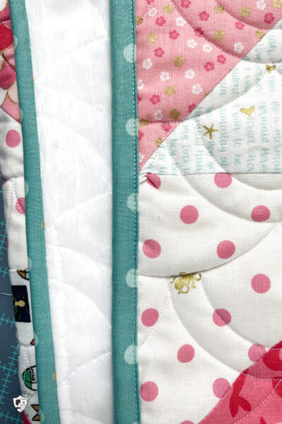 aqua binding shown on the edge of a quilt