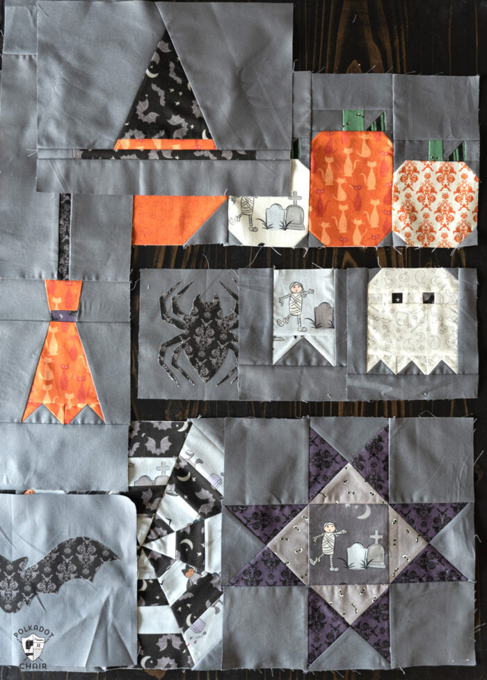 gray, orange and black quilt blocks on black table