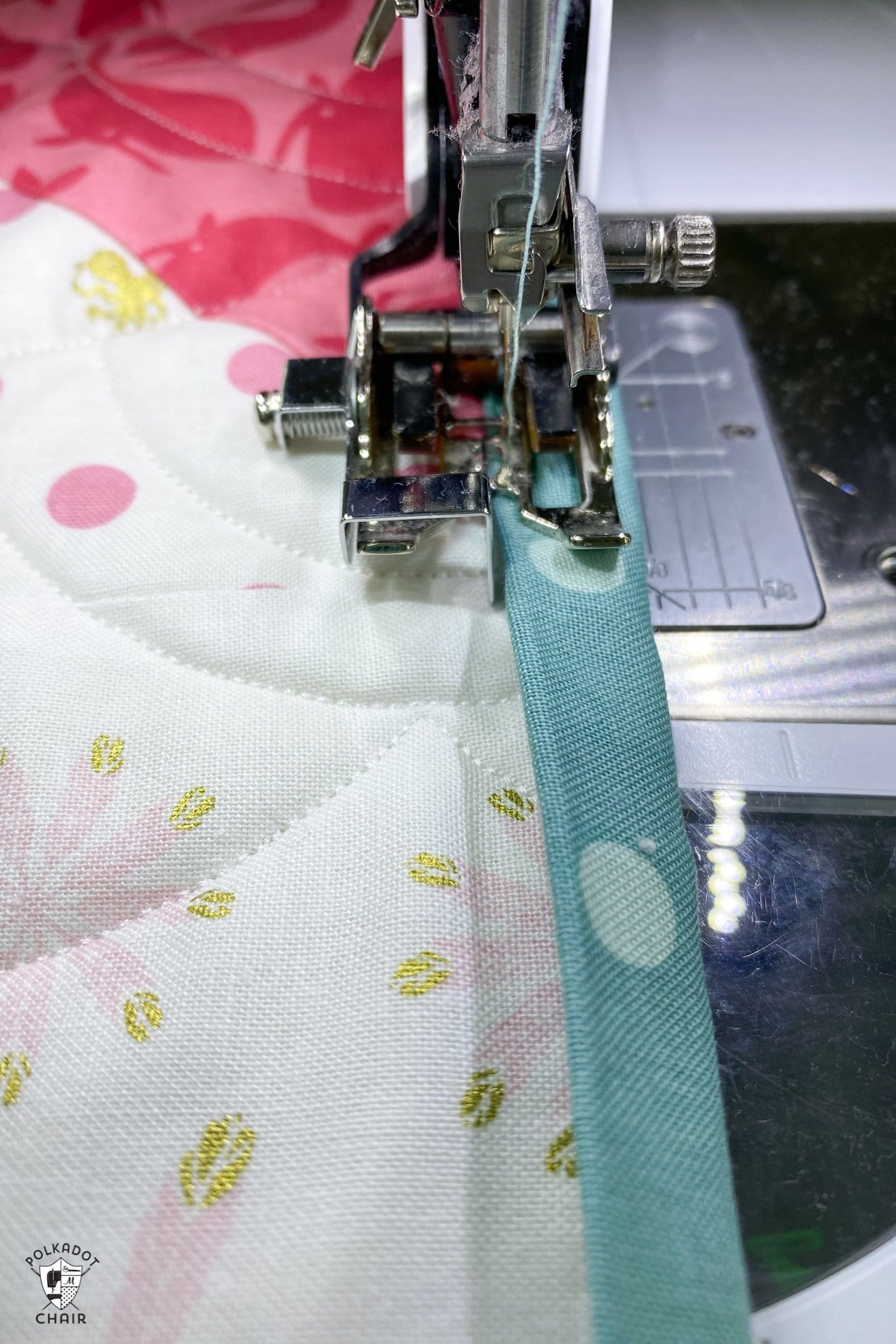close up of sewing machine foot on machine with fabric underneath