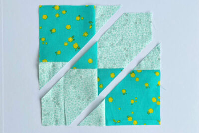 aqua, blue, & orange quilt blocks on white table