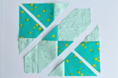 aqua, blue, & orange quilt blocks on white table