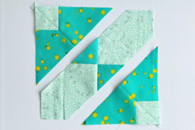 aqua, blue, & orange quilt blocks on white table