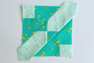 aqua, blue, & orange quilt blocks on white table