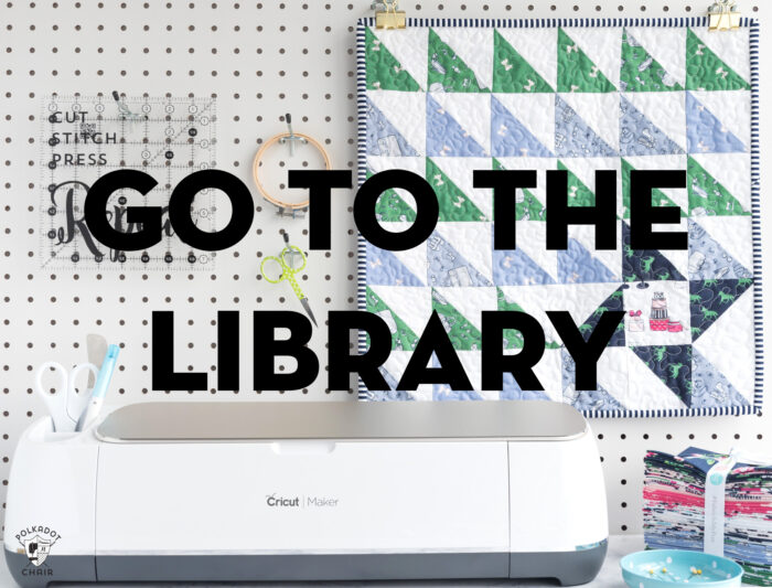 cricut machine on table with stack of fabric